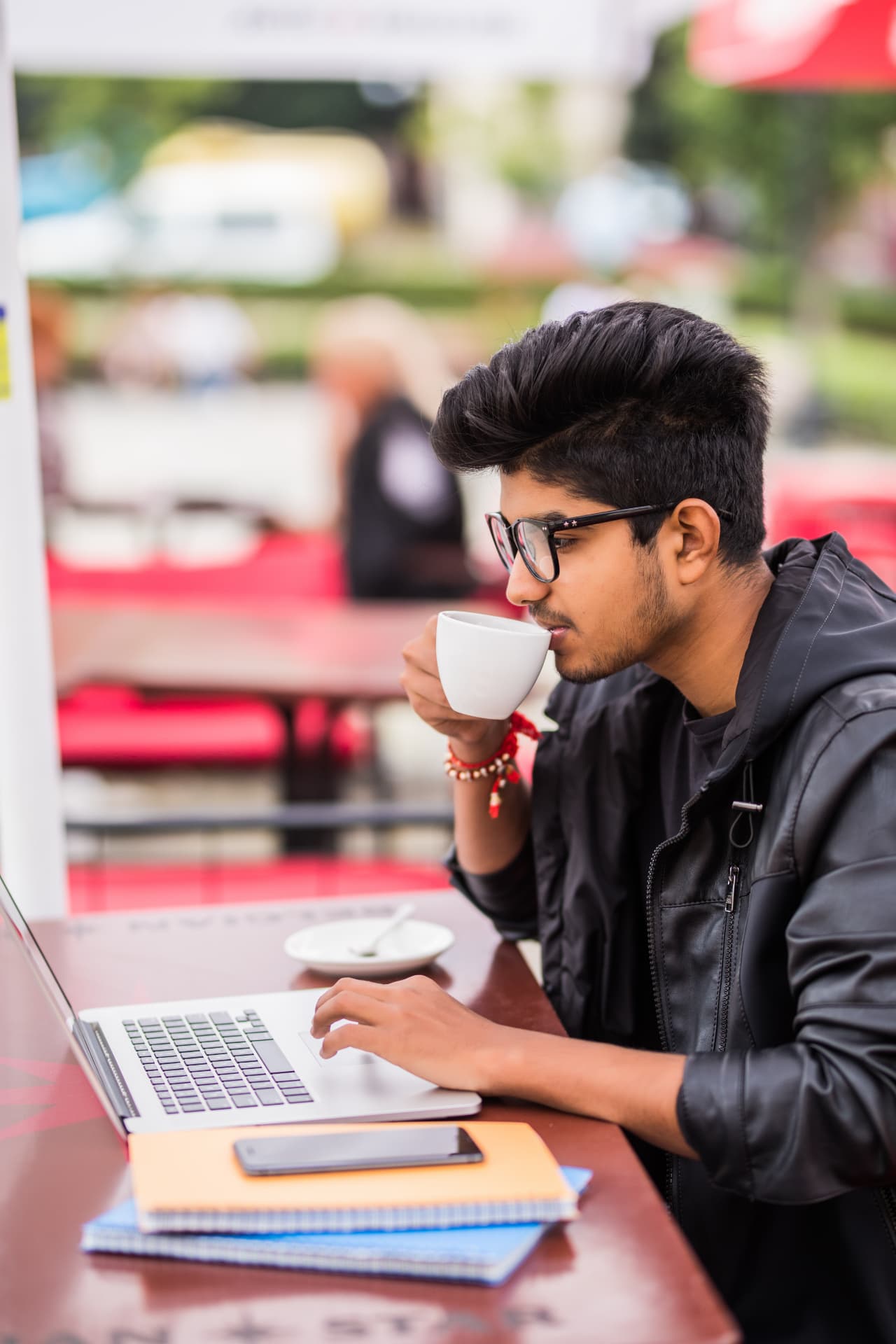 A PBS learner studying on a laptop over coffee